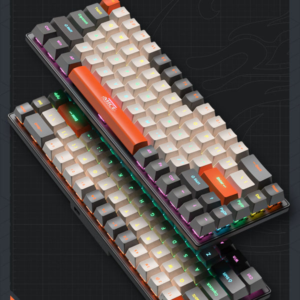 Two overlapping compact keyboards with cream and grey keycaps, orange accent keys and multicoloured backlighting, viewed at an angle.